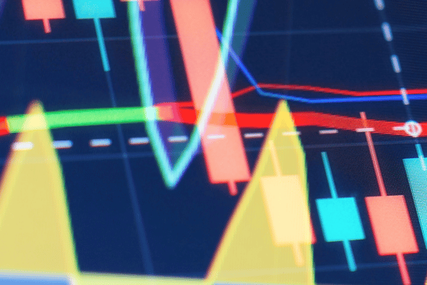 Close-up of a stock market chart showing red and green candlestick bars with fluctuating trend lines.